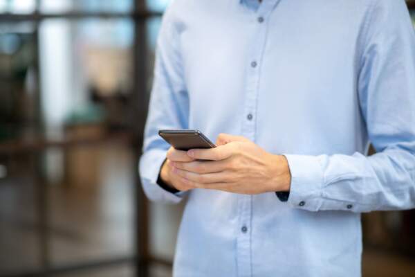 close-up-picture-of-a-man-holding-a-smartphone-2024-10-17-02-39-49-utc (1) (1)