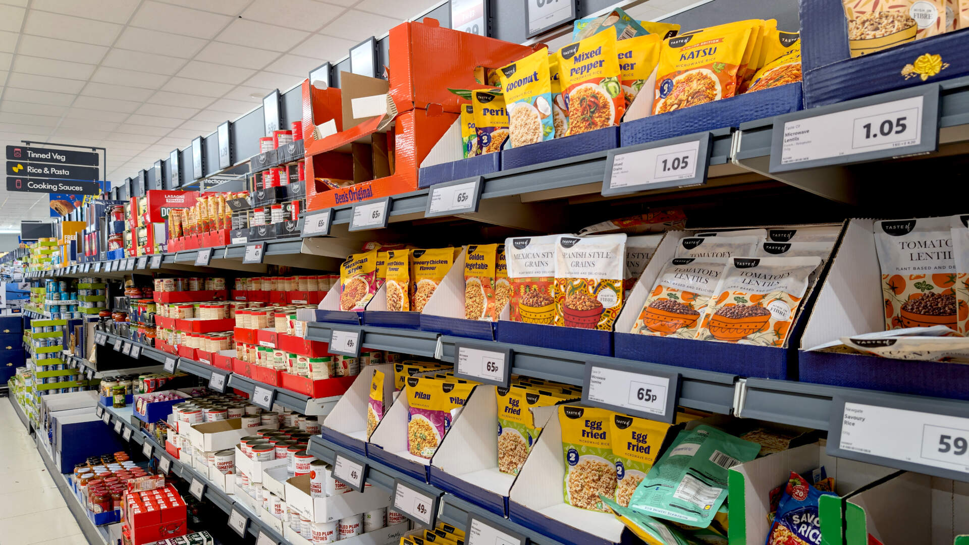 Leicester, England, UK – 10 May 2025: Lidl store shelf view showcasing packaged ready-meals, rice, sauces, and cooking kits for quick dinner concepts